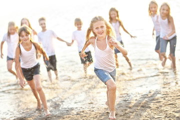 Wall Mural - Portrait of children on the beach in summer