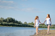 © zagorodnaya - portrait of two sisters walking on the beach