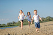 © zagorodnaya - three children playing on beach in summer