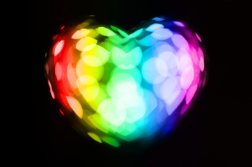 Wall Mural - Sparkling rainbow bokeh heart on black background