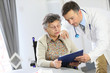 © goodluz - Doctor with elderly woman in nursing home