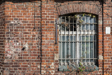 Forgotten Building With Bars On The Window