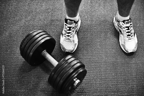 Fototapeta na wymiar Barbell and feet