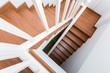 © sutichak - wooden staircase made from laminate wood in white modern house