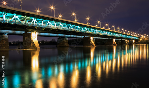 Obraz w ramie Highlighted bridge at night and reflected in the water.Bridge Gd