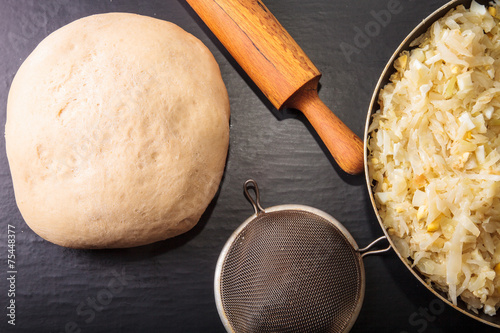 Fotografie, Obraz Rolling pin, dough and a cabbage filling for pie