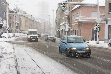 Naklejka na meble Snowy winter road with cars driving