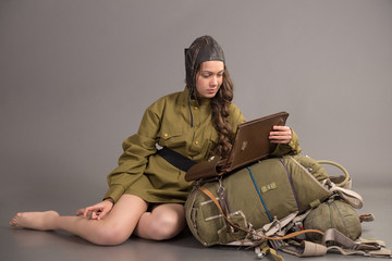 Wall Mural - girl in uniform of the Soviet army sits on parachute