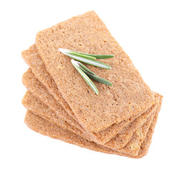 Crispbread with sprigs of rosemary isolated on white background