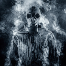 A Man In A Gas Mask Shrouded In Smoke
