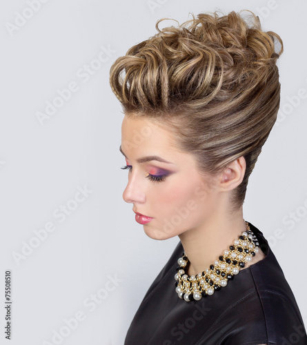 Naklejka na szybę Beautiful young woman with evening make-up and salon hairstyle