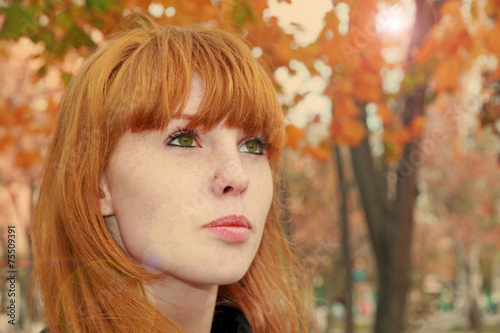 Pretty Red Hair Face With Freckles Against Autumn Folia Pretty Red Hair Face With Freckles Against Autumn Folia