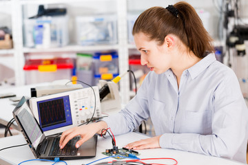 Poster - woman with a tester and a printed circuit board