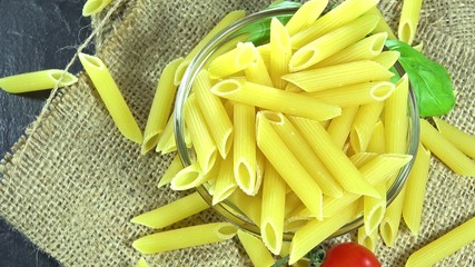 Canvas Print - Portion of raw Penne as seamless loopable 4K footage