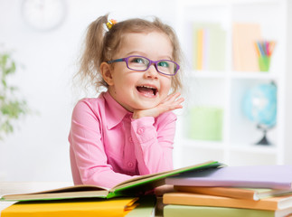 Happy kid reading books and dreaming