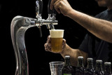 Fototapeta  - Man drawing beer from tap
