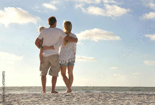 Happy Family On Beach Vacation Looking at Ocean Poster