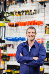 Wall Mural - Worker Standing Arms Crossed In Hardware Shop