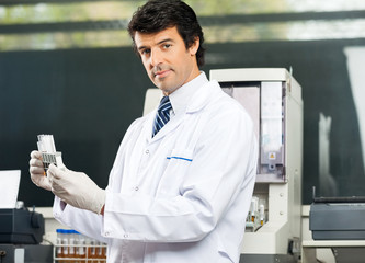 Wall Mural - Confident Scientist Analyzing Urine Samples In Lab