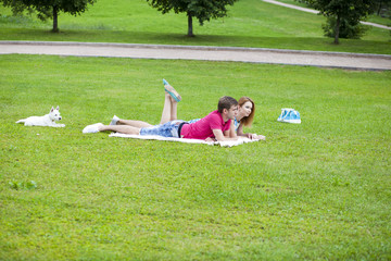 Young couple lying in the park on a summer day