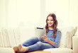 © Syda Productions - smiling teenage girl with tablet pc at home