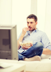 Sticker - smiling man watching sports at home