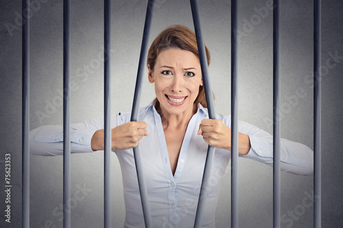 Fotografia, Obraz  Stressed desperate angry woman bending bars of her prison