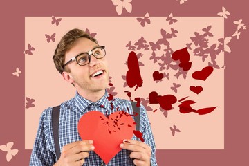 Poster - Composite image of geeky hipster holding a heart card