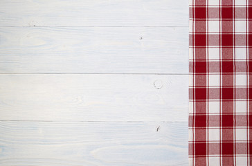 Wall Mural - red folded tablecloth over old wooden table