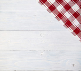 Wall Mural - red folded tablecloth over old wooden table