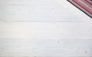 Wall Mural - red folded tablecloth over old wooden table