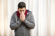 © theartofphoto - Young man feeling very cold, wearing heavy sweater and scarf