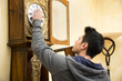 © theartofphoto - Young man checking a pendulum and winding the mechanism