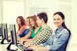 © Syda Productions - female student with classmates in computer class