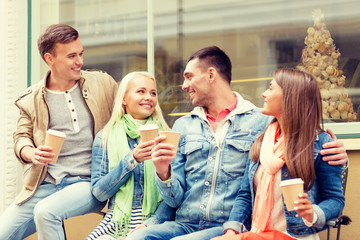 Canvas Print - group of smiling friends with take away coffee