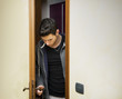 © theartofphoto - Handsome young man opening door to enter