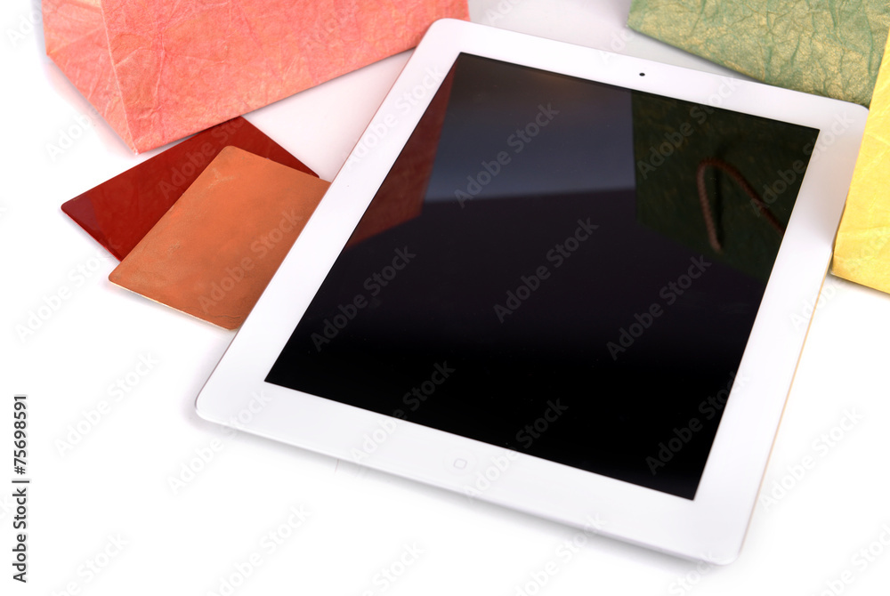 Computer tablet with credit card and paper bags