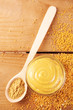 Composition of different kinds of mustard on wooden background