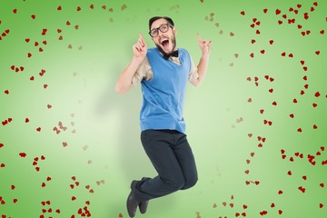 Poster - Composite image of geeky hipster jumping and smiling