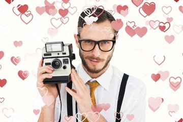 Poster - Composite image of geeky hipster holding a retro camera