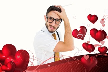 Leinwandbilder - Composite image of geeky hipster scratching his head