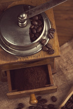 Top View Over Old Manual Coffee Grinder On Wooden Table