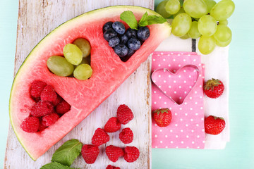 Wall Mural - Fresh juicy watermelon slice  with cut out heart shape, filled