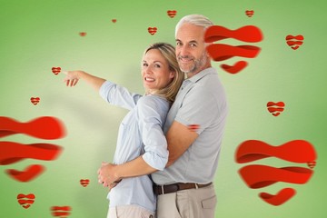 Aufkleber - Composite image of happy couple smiling at camera and pointing