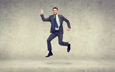 Canvas Print - smiling businessman jumping