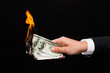 © Syda Productions - close up of male hand holding burning dollar money
