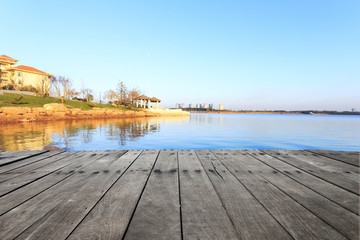 Wall Mural - skyline and lake with plank board  near resort in suburb.