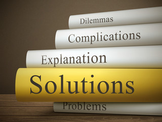 book title of solutions isolated on a wooden table