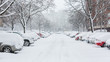Cars covered in snow on a parking lot in the residential area 