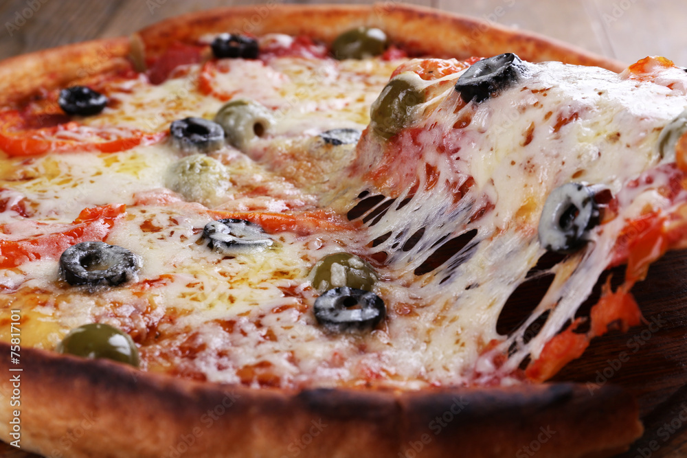 Pizza with cheese on board and wooden table background